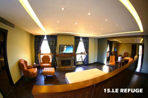 a large living room with a bed and a tv at Layali Al Shams Hotel in ‘Anjar