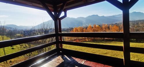 a view from the porch of a cabin with autumn trees at Cabana Ciresarii in Sohodol