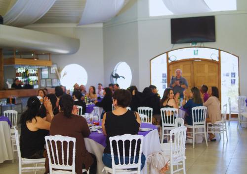 a group of people sitting in chairs in a room at Hostería Valle Verde in Villa Alemana