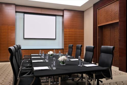 a conference room with a long table and chairs at Crowne Plaza Dubai Festival City in Dubai