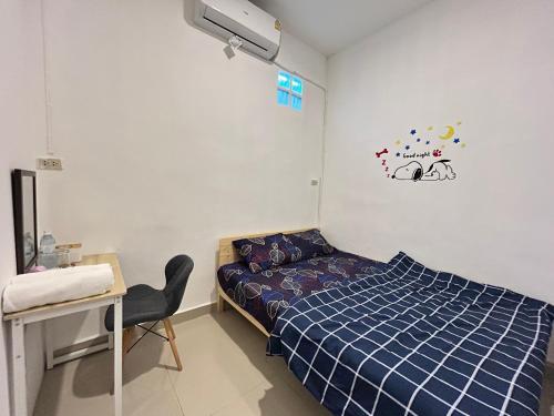 a bedroom with a bed and a desk and a chair at LUB D Betong Hostel in Betong