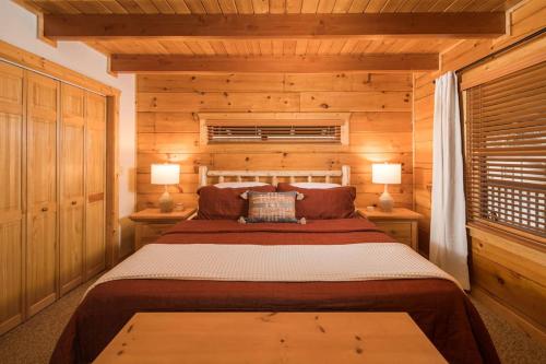 a bedroom with a bed in a log cabin at Wrap-Around Porch, Hot Tub and Game Room in Blowing Rock