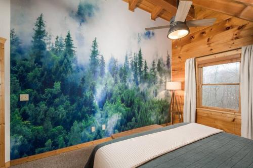 a bedroom with a large mural of a forest at Wrap-Around Porch, Hot Tub and Game Room in Blowing Rock
