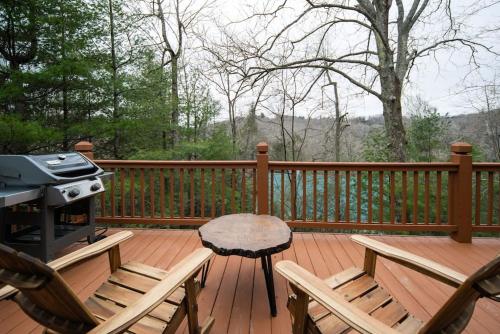 a grill and chairs on a wooden deck with a table at Wrap-Around Porch, Hot Tub and Game Room in Blowing Rock