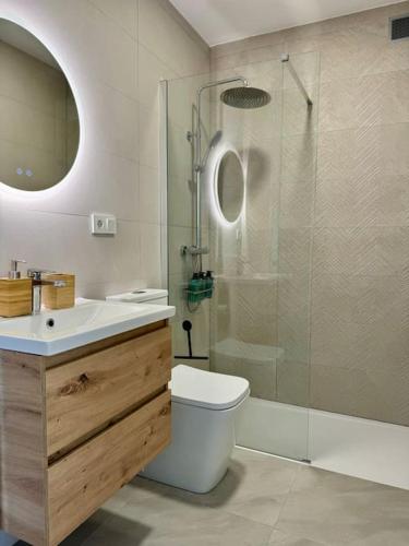 a bathroom with a shower and a toilet and a sink at Cozy apartment with port view in Torrevieja