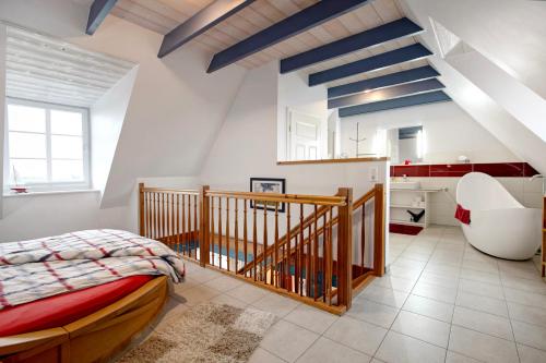 a bedroom with a bed and a bathroom with a sink at Fewo Kastanienhof in Pellworm