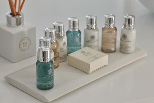 a shelf with a bunch of bottles on it at Mykonos Earth Suites in Mýkonos City