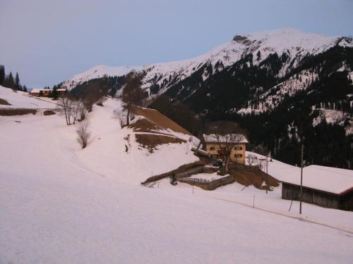a house on a snow covered slope with a mountain at Bellevue in Pany