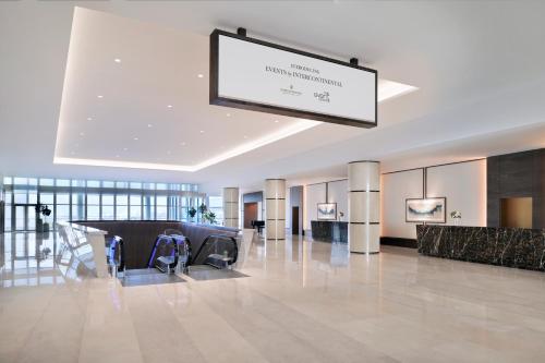 a large lobby with a sign hanging from the ceiling at InterContinental Dubai Festival City by IHG in Dubai
