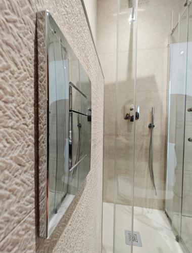 a shower with a glass door in a bathroom at Blue Pearl in Żurrieq