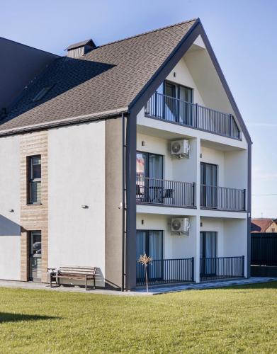 a large white building with a black roof at Апартаменти Velvet Rooms in Skhidnitsa