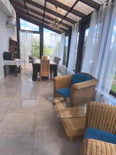 a living room with chairs and a table and windows at GOSPODARSTWO TURYSTYCZNE w OSINKACH in Suwałki