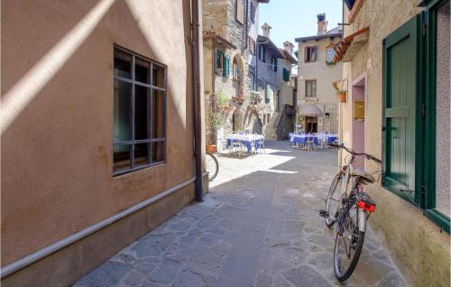 a bike parked on a street next to a building at Stunning Apartment In Rivignano Teor in Teòr