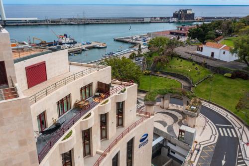an aerial view of a building with a marina at Stay In St. Catarina Park, by PAUSA H. Rentals in Funchal