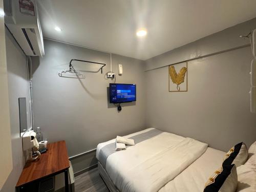 a hospital room with a bed and a tv at SS Grey House in Kuala Lumpur