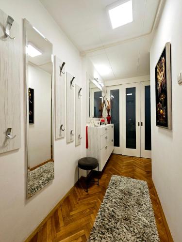 a bathroom with a vanity and a mirror at Deluxe Jade Apartmens in Niš