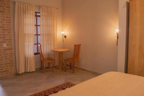 a small room with a table and two chairs at Casa Irene in Teotitlán del Valle