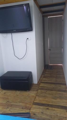 a flat screen tv on a wall in a room at Glamping en villa 2 in Villa de Leyva