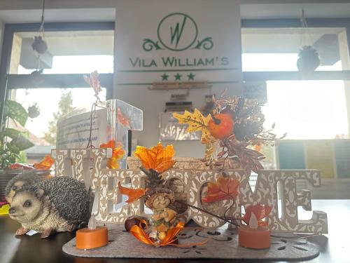 a table with a hedgehog and autumn decorations on it at Vila William’s in Braşov
