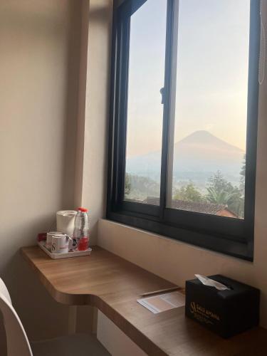 a window in a room with a view of a mountain at SALU AMAANA Residence Syariah in Wonosobo