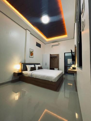 a bedroom with a bed and a television in it at SALU AMAANA Residence Syariah in Wonosobo