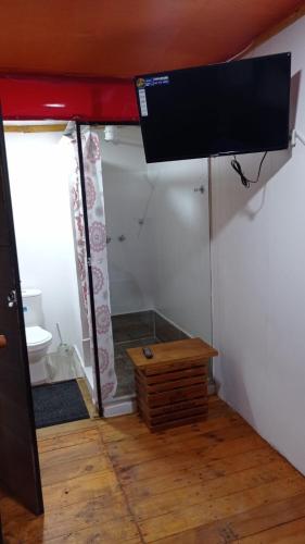 a room with a bed and a tv on a wall at Glamping en villa 2 in Villa de Leyva