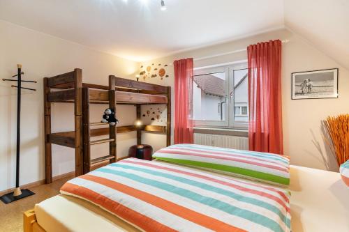 a bedroom with two bunk beds and a window at Haus Ursula in Ettenheim