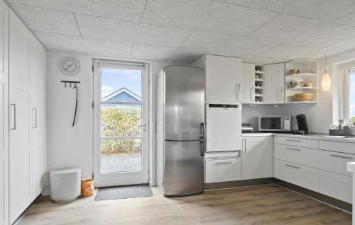 a kitchen with a stainless steel refrigerator and a window at Cozy Home In Haderslev With Wifi in Haderslev