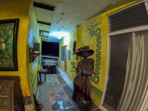 a hallway with a mural of a woman on a wall at Casa Artista in Manzanillo