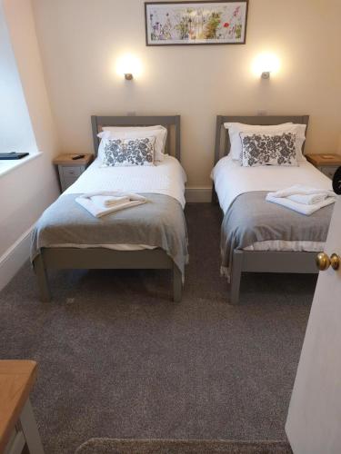 a bedroom with two beds and a picture on the wall at Red Lion in Exeter