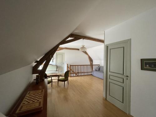 a living room with a staircase and an attic at LA BELLE ETOILE in Valençay