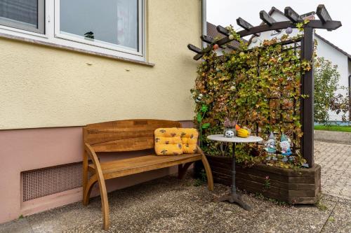 a bench and a table next to a wall at Haus Ursula in Ettenheim