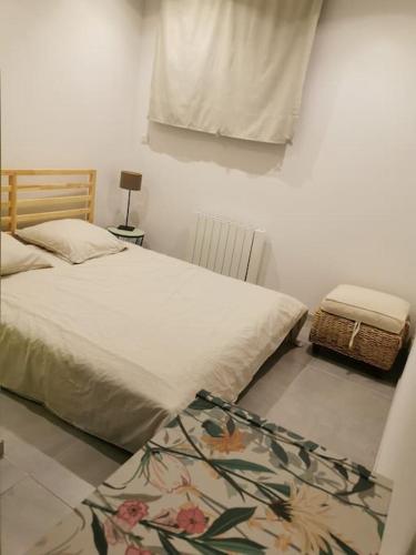 une chambre avec un lit et un tapis au sol dans l'établissement charmant appartement au cœur du village, à Claret