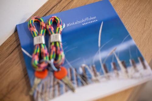 a book sitting on a table with candy canes at Winkelschiffchen V im Ortszentrum Juist in Juist