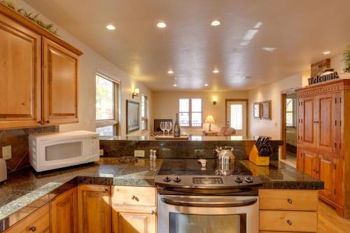 a kitchen with a stove and a microwave at Patio and Mountain Views Central Ouray Getaway! in Ouray