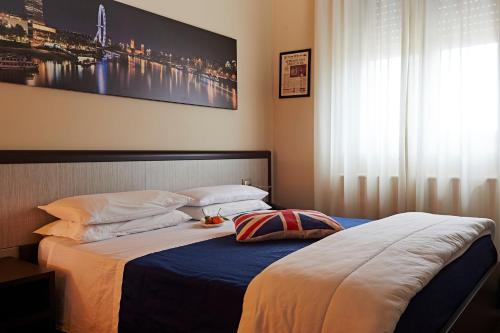 a bedroom with a bed with a picture on the wall at Aleksandr in Brindisi