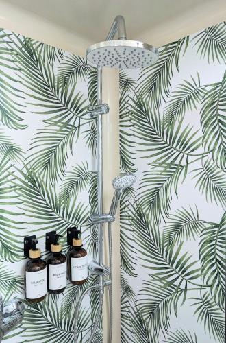 a bathroom with four bottles of essential oils on a wall at Neu! Moderner bayrischer Flair vor Pilatushaus in Oberammergau