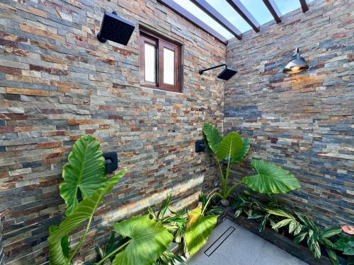 a brick wall with plants in front of it at Villa Solara 6 - Luxury 6 Bedroom Villa with Pool, Golf & Lake View in Río Hato