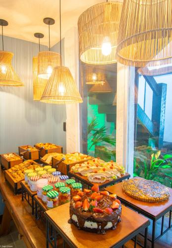 a buffet with many different types of cakes and pastries at Chez Pitu Praia Hotel in Búzios