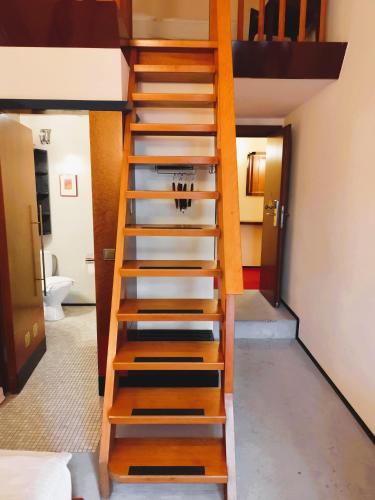 a wooden staircase in a room with a bathroom at Domicil Hotel Bonn in Bonn