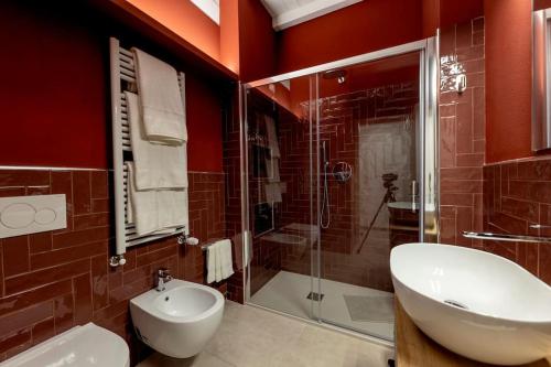 a bathroom with a toilet and a sink and a shower at Red Suite - City center & Garage in Parma