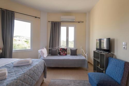 a hotel room with two beds and a television at La Vatura in Gialova