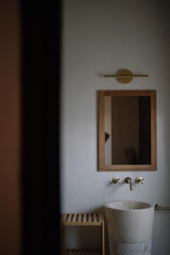 a bathroom with a sink and a mirror at Taga Suites in Catania