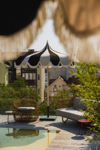 a black and white umbrella sitting next to a pool at AS Boutique Hotel, superior in Ljubljana