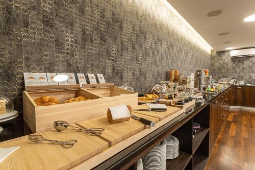 a restaurant with a long counter with glasses on it at ABC Swiss Quality Hotel in Chur