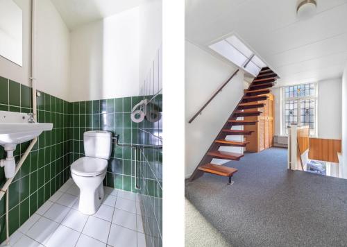a bathroom with a toilet and a sink and a staircase at Charmant appartement in de binnenstad van Leeuwarden in Leeuwarden