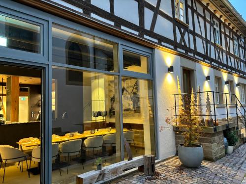 a restaurant with tables and chairs in a building at Gasthaus Faust in Knittlingen