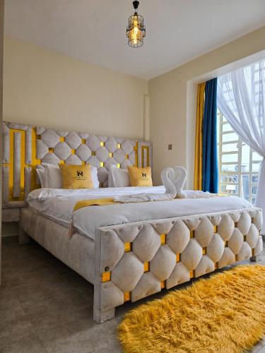 Postel nebo postele na pokoji v ubytování Nyumbani Vibes - Treands Apartment