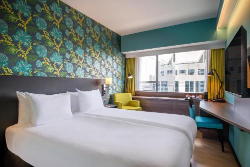 a hotel room with a large bed and a window at Thon Hotel Brussels City Centre in Brussels