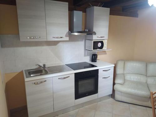 a small kitchen with a sink and a microwave at Little House in Bracciano